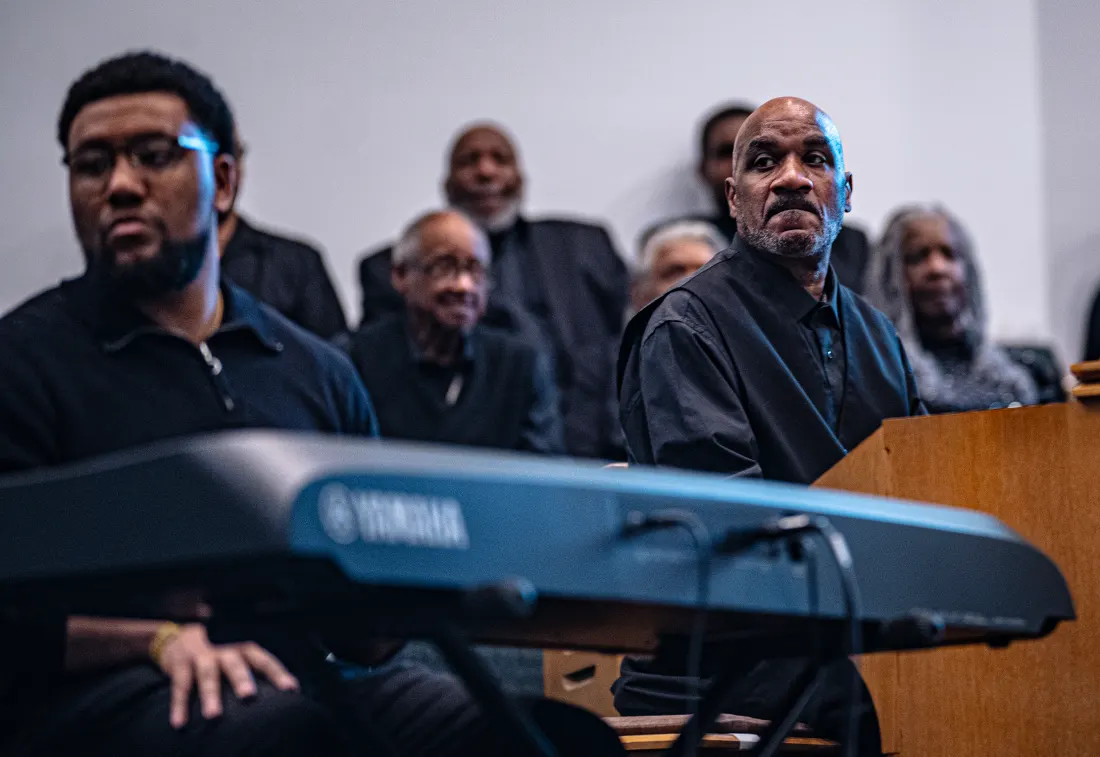 Church congregation with hands raised during worship — placeholder