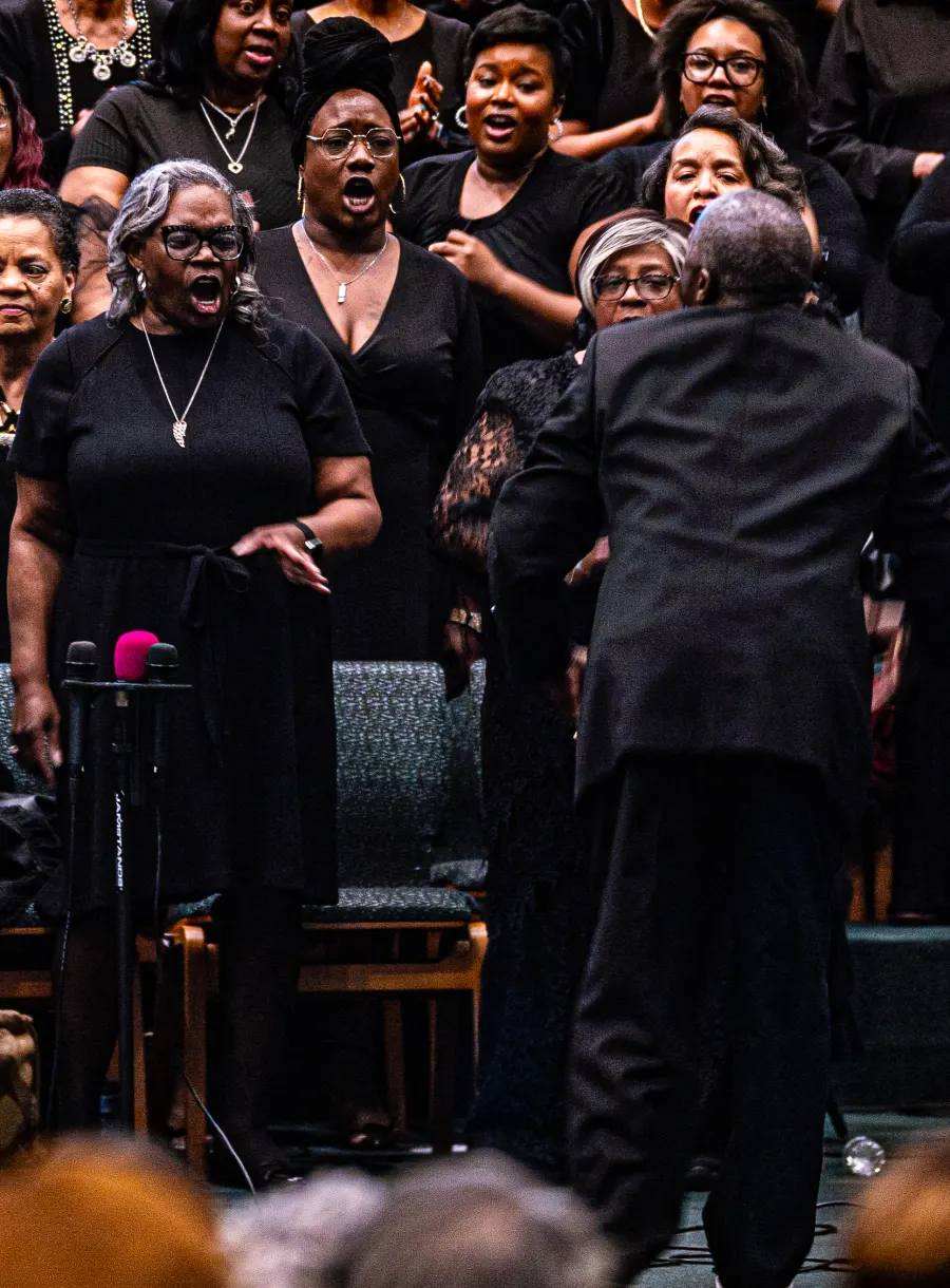 Church congregation with hands raised during worship — placeholder